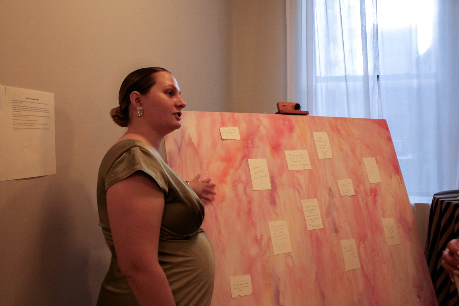 Alexandra Jabot stands beside the Struggle canvas, covered in handwritten notes