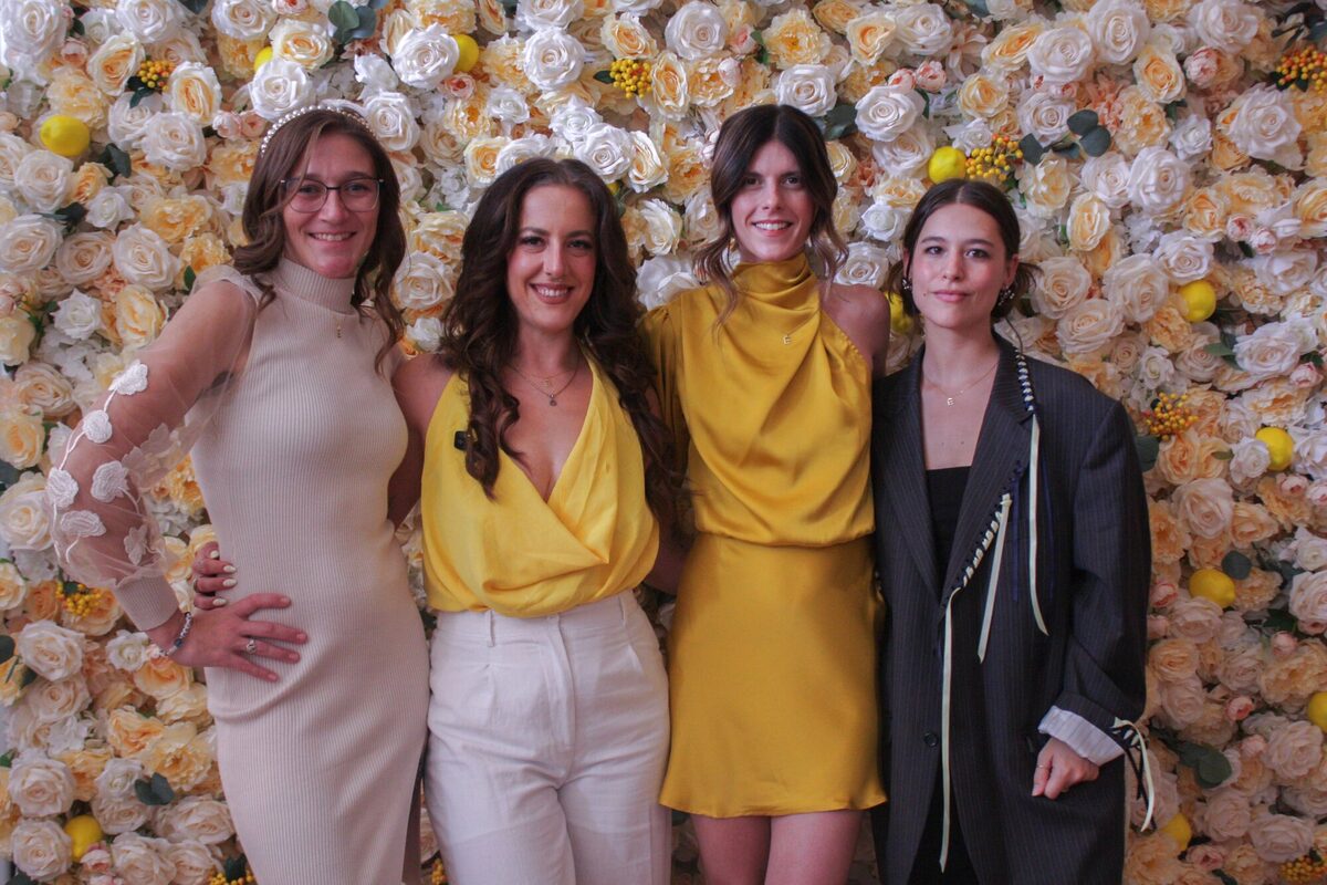 The 2026 exhibition team in front of the flower wall